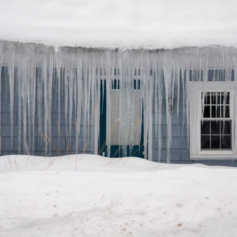 Icicles haging from ice dam roof in New England